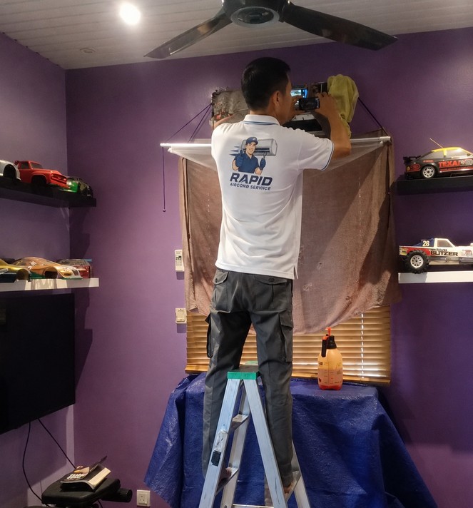 Aircond chemical wash with a protective catcher bag in a Malaysian home